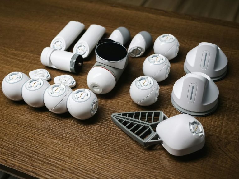 Close-up of unassembled robot components showcasing futuristic and innovative technology on a wooden surface.